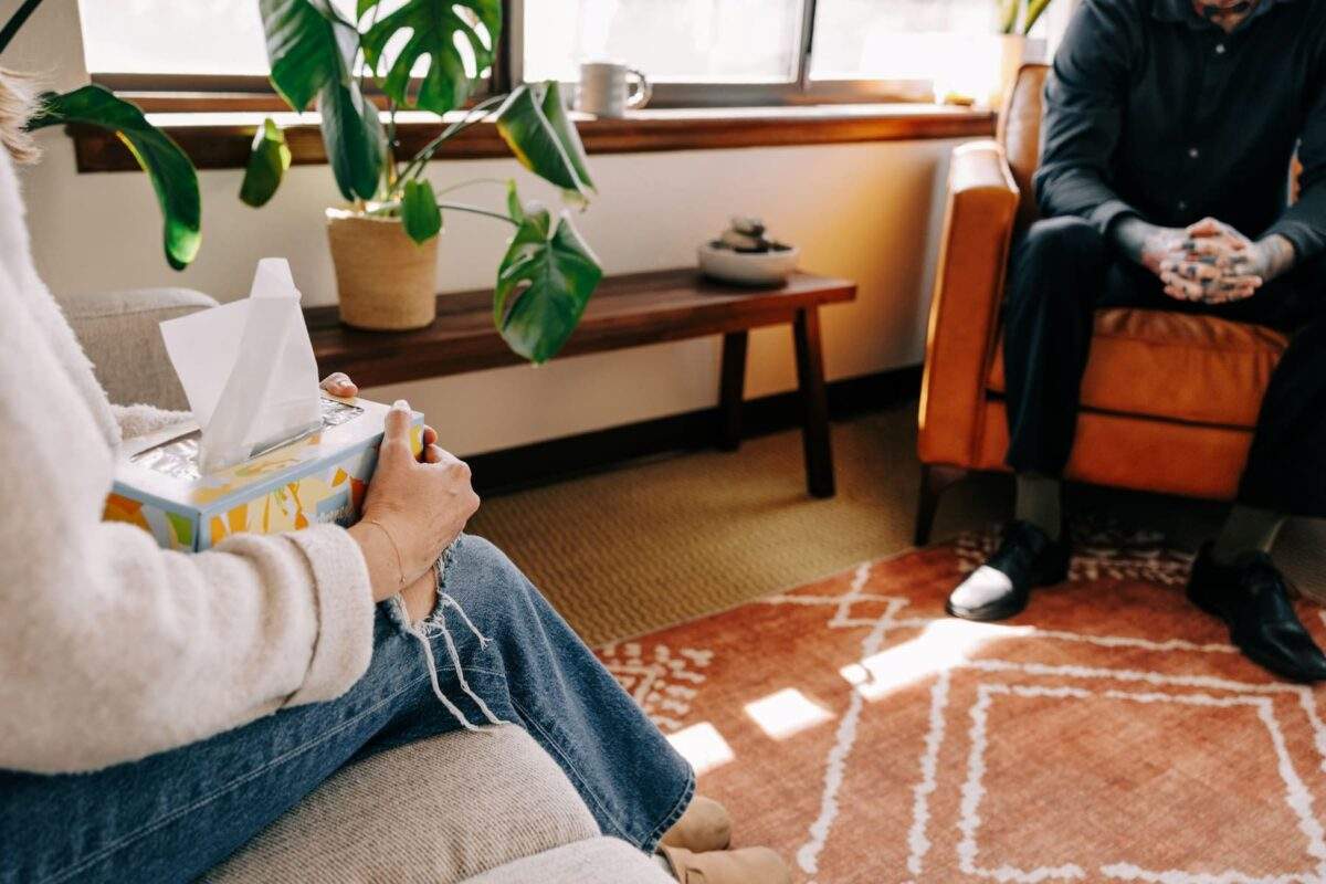 Person holding a tissue box during a therapy session for treatment-resistant depression at Zephyr Behavioral Health.